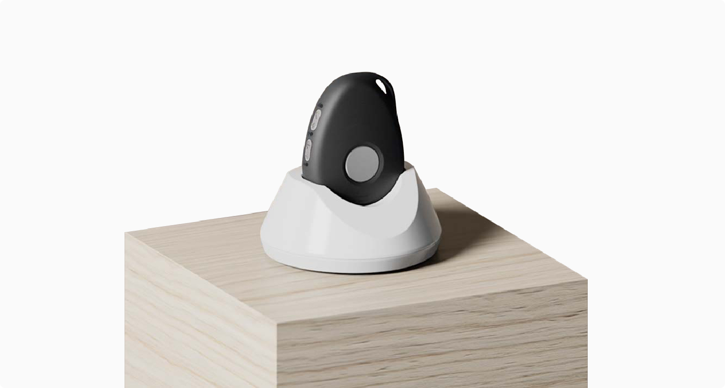 A removable medical alert button in a tabletop dock.