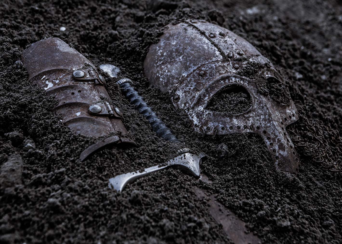 A photo of a viking burial with a face shield and sword