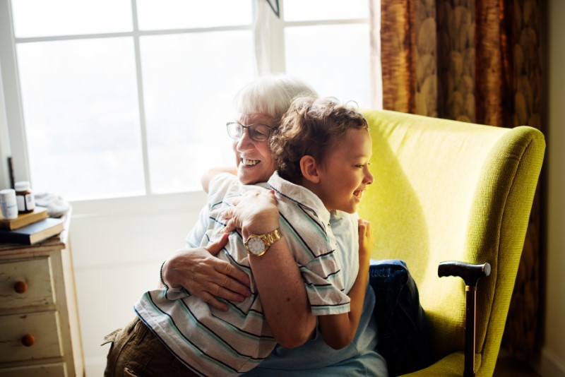 Grandma and grandson hugging in living room