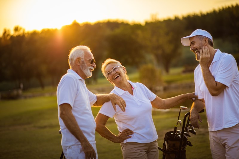 Three seniors golfers talking on golf course