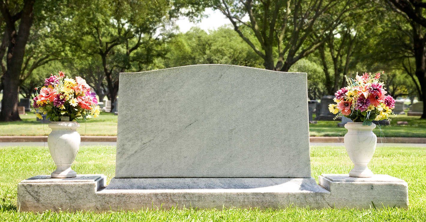 A single blank headstone in a cemetery.