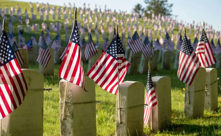 tombstones with American flags at a veterans cemetary