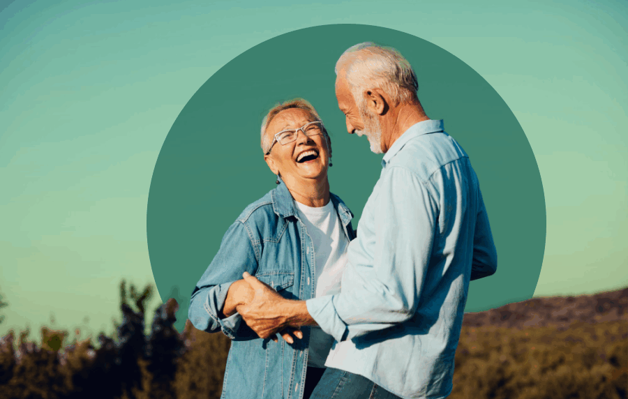 White senior couple smiling and laughing outdoors