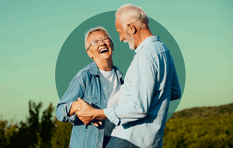 White senior couple smiling and laughing outdoors