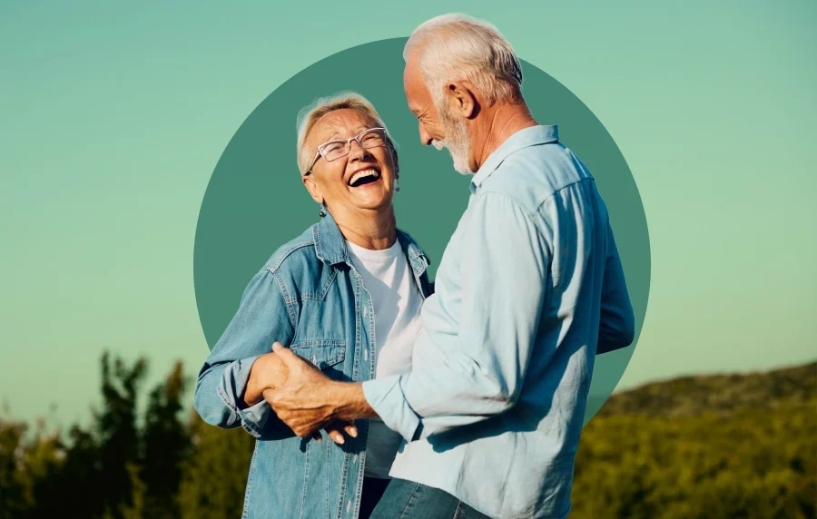 White senior couple smiling and laughing outdoors