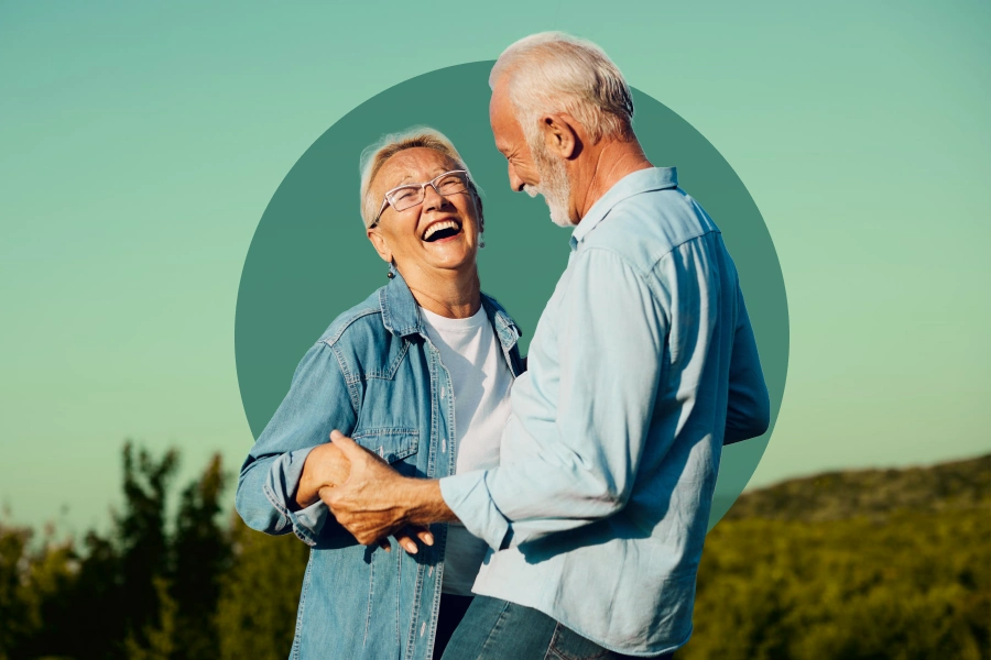White senior couple smiling and laughing outdoors