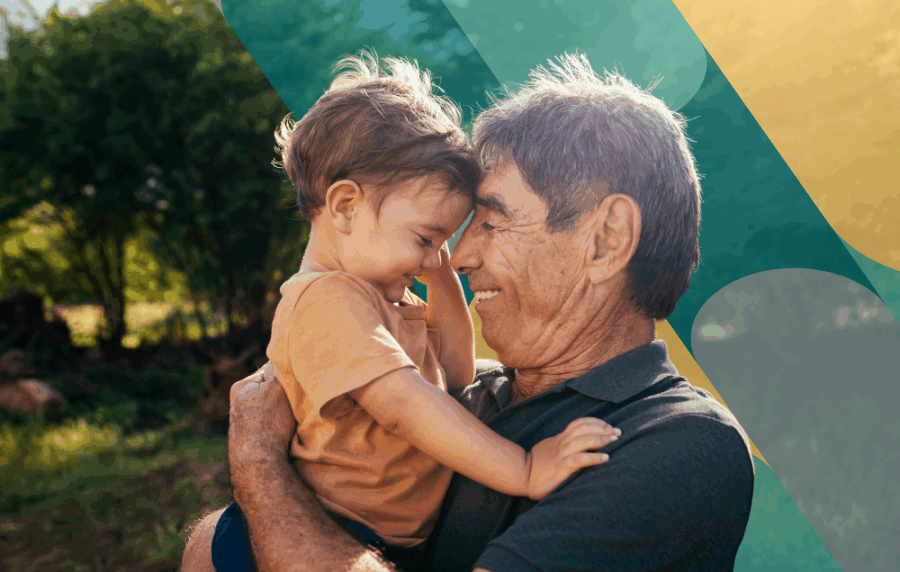 Senior man with toddle in his arms, their faces and bodies in profile